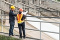 Engineering team Men and woman meeting with Engineers and supervisors are standing reading the blueprints at construction site Royalty Free Stock Photo