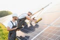 Engineering team working on checking and maintenance in solar power plant, Solar panel technician installing solar Royalty Free Stock Photo