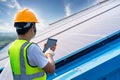 Engineering use a tablet working on roof checking and maintenance in solar power plant , solar power plant to innovation of green