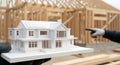 Engineering House Model In Front Of Wooden Home Frame Under Construction Site Royalty Free Stock Photo