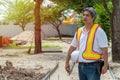 Engineering wearing a white safety helmet standing In front of the construction site And using tablet to construction. Concepts fo Royalty Free Stock Photo