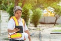 Engineering wearing a white safety helmet standing In front of the construction site And using tablet to construction. Concepts fo Royalty Free Stock Photo