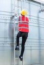 Engineering or worker descended the fire escape to the safe zone. Man in Fire escape to the roof. Worker climbing down fire escape