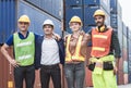 Engineering workers standing in front of industrial containers