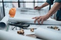 Engineering working with drawings inspection on the office desk and Calculator, triangle ruler, safety glasses, compass, vernier