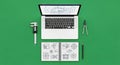 Engineering Workspace: Laptop, Caliper, Compass, and Technical Drawings on Green Background Royalty Free Stock Photo
