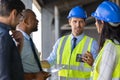 Engineers and architects in conversation at building site Royalty Free Stock Photo