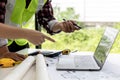 Engineers and architects pointing at laptop screens looking at blueprints to make some modifications. Royalty Free Stock Photo