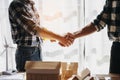 Engineers or architecture shaking hands at construction site for architectural project, holding safety helmet on their hands Royalty Free Stock Photo