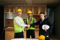 Engineers or architecture shaking hands at construction site for architectural project, holding safety helmet on their hands. Royalty Free Stock Photo