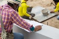Engineers on building site checking plans. Engineer or architect of building plan for construction at job site, Royalty Free Stock Photo