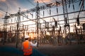 Engineers are checking the operation of the system by laptop, weekly check the system of the power distribution station for errors