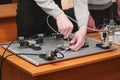 Engineers connect wires control panel with small test bench for experiments