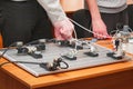 Engineers connect wires control panel with small test bench for experiments