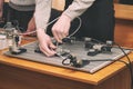 Engineers connect wires control panel with small test bench for experiments