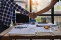 Engineers and construction supervisors shake hands after a consultation meeting to begin planning a new contract in the constructi Royalty Free Stock Photo