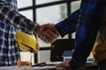 Engineers and construction supervisors shake hands after a consultation meeting to begin planning a new contract in the constructi Royalty Free Stock Photo