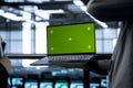 Engineers in data center using green screen laptop, reviewing equipment health