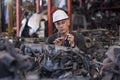 Engineers in the factory. A skilled mechanic inspecting auto parts in a factory