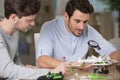 engineers fixing square copter at table Royalty Free Stock Photo
