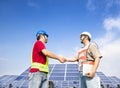 Engineers handshaking before solar power station