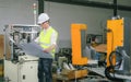 Engineers in hard hats working at the industrial plant