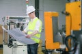 Engineers in hard hats working at the industrial plant