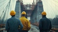 Engineers in helmets observing bridge construction site with focus Royalty Free Stock Photo