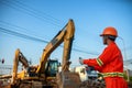 Engineers inspect the backhoe on the construction site