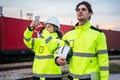 Engineers Inspecting Freight Operations at Rail Yard, Logistics Team on Duty at Industrial Train Terminal, Logistics Team Royalty Free Stock Photo