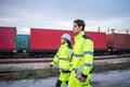 Engineers Inspecting Freight Operations at Rail Yard, Logistics Team on Duty at Industrial Train Terminal, Logistics Team Royalty Free Stock Photo