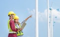 Engineers looking at wind turbine site with tablet Royalty Free Stock Photo