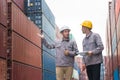 Engineers man team managing cargo operations, Foreman dock workers checking containers box at shipping yard Royalty Free Stock Photo