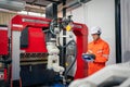 Engineers mechanic using computer controller Robotic arm for welding steel in steel factory workshop. Industry robot programming