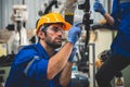 Engineers mechanic using computer controller Robotic arm for welding steel in steel factory workshop. Industry robot programming