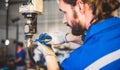 Engineers mechanic using computer controller Robotic arm for welding steel in steel factory workshop. Industry robot programming