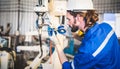 Engineers mechanic using computer controller Robotic arm for welding steel in steel factory workshop. Industry robot programming