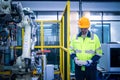 Engineers mechanic using computer controller Robotic arm for welding steel in steel factory workshop. Industry robot programming