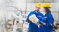 Engineers mechanic using computer controller Robotic arm for welding steel in steel factory workshop. Industry robot programming Royalty Free Stock Photo