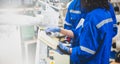 Engineers mechanic using computer controller Robotic arm for welding steel in steel factory workshop. Industry robot programming Royalty Free Stock Photo