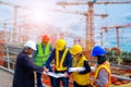 Engineers Meeting for successful project construction Team of professional engineers working with blueprints. Royalty Free Stock Photo