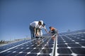 Engineers Placing Solar Panel Against Sky Royalty Free Stock Photo