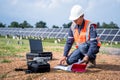 Engineers preparing drones to fly, inspecting the solar cells at high angles to thermo scan the solar panel for potential