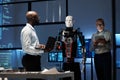 Engineers programming robot with gadgets
