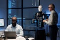 Engineers programming robot in the lab