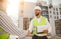 Engineers shaking hands at construction site Royalty Free Stock Photo