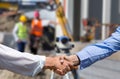 Engineers shaking hands on construction site Royalty Free Stock Photo