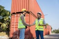 Engineers shaking hands in logistics and container management for import and export Royalty Free Stock Photo