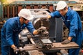 Engineers and skilled technicians are maintaining machinery. Engineers are working and repairing machines in industrial