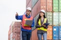Engineers team managing cargo operations, Engineer and foreman dock worker checking containers box at shipping yard Royalty Free Stock Photo